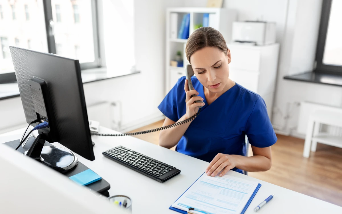 A front-desk executive taking a client call